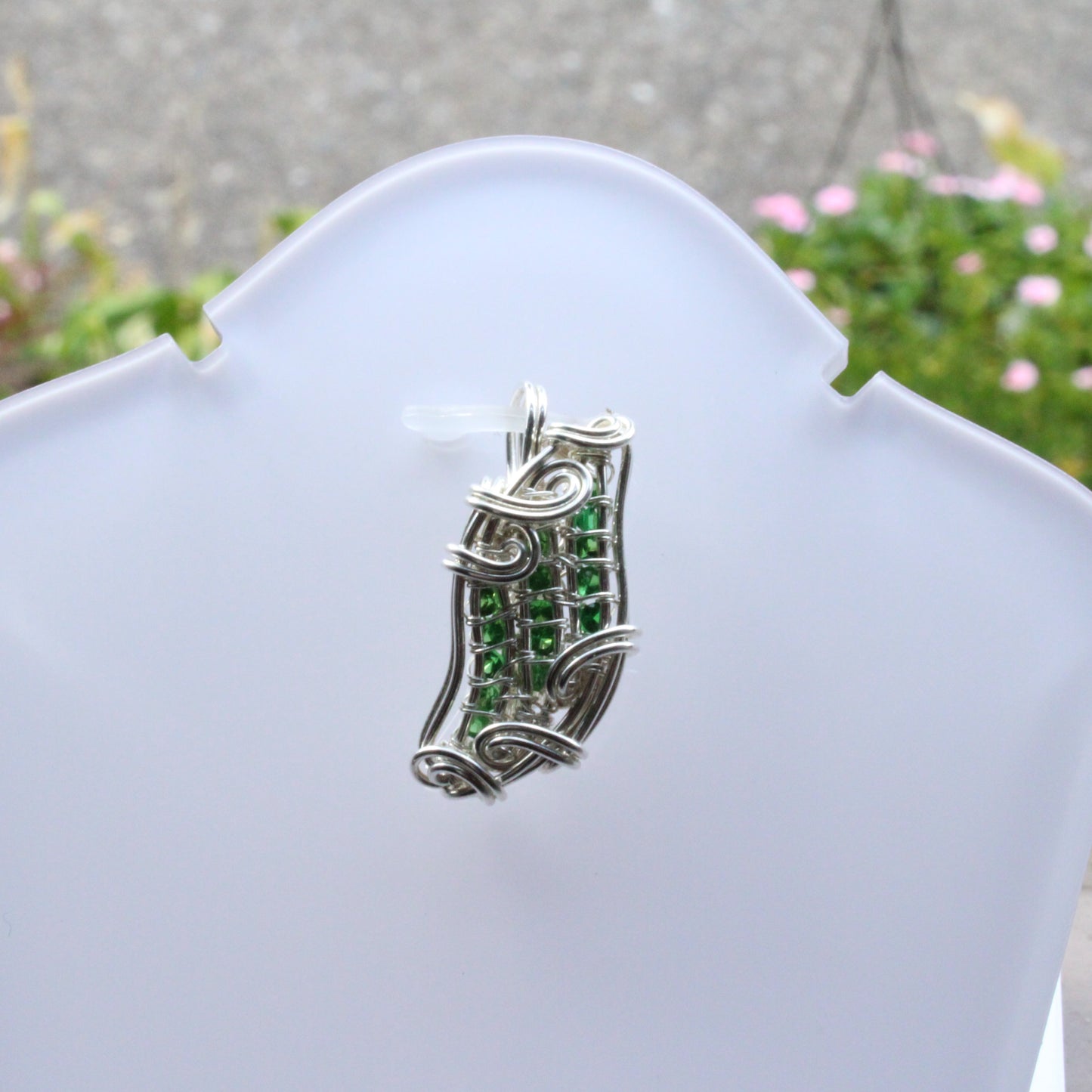Elegant Tsavorite Sterling Silver Pendant featuring intricate wire designs and vibrant green gemstones