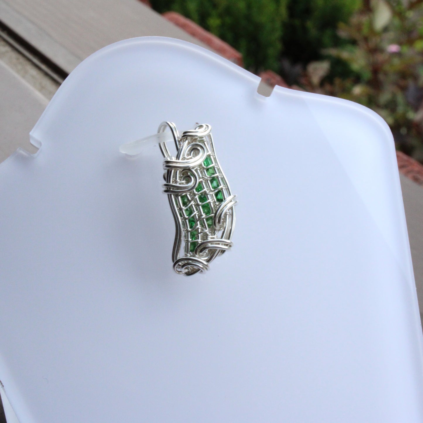 Tsavorite Sterling silver Pendant featuring an intricate wire design and vibrant green gemstones
