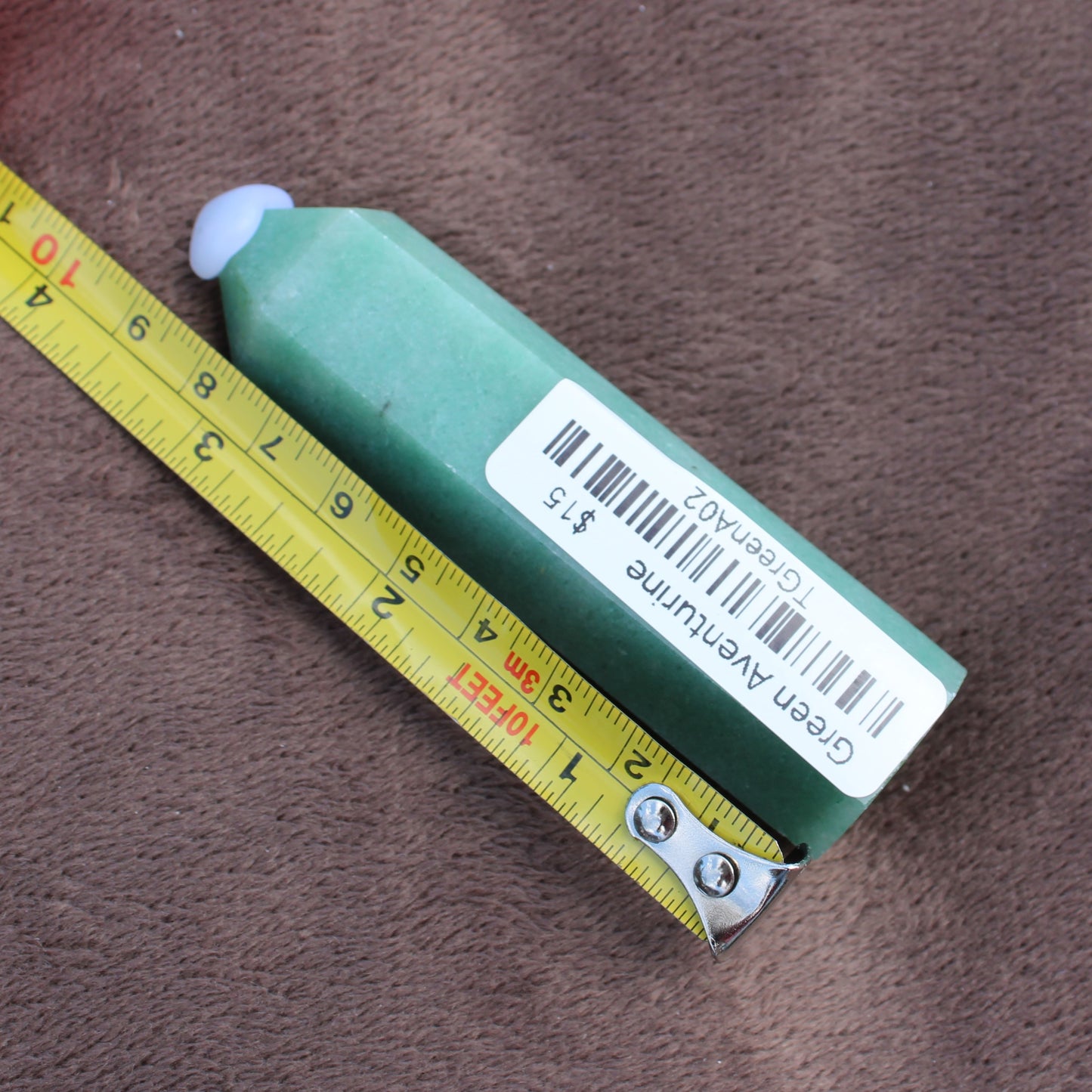 Green Aventurine Tower crystal measuring about 4 inches with label from Different Branches LLC