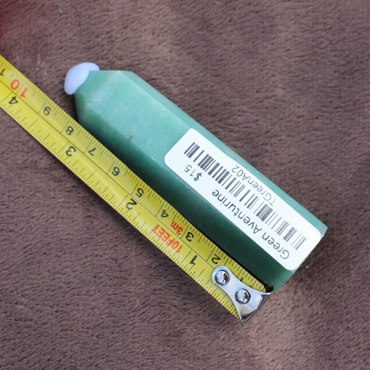 Green Aventurine Tower crystal measuring about 4 inches with label from Different Branches LLC
