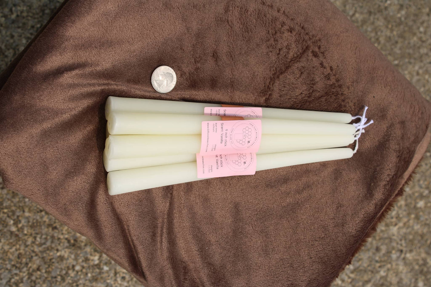 Set of white taper candlesticks by Different Branches LLC displayed on a soft surface with a coin for scale