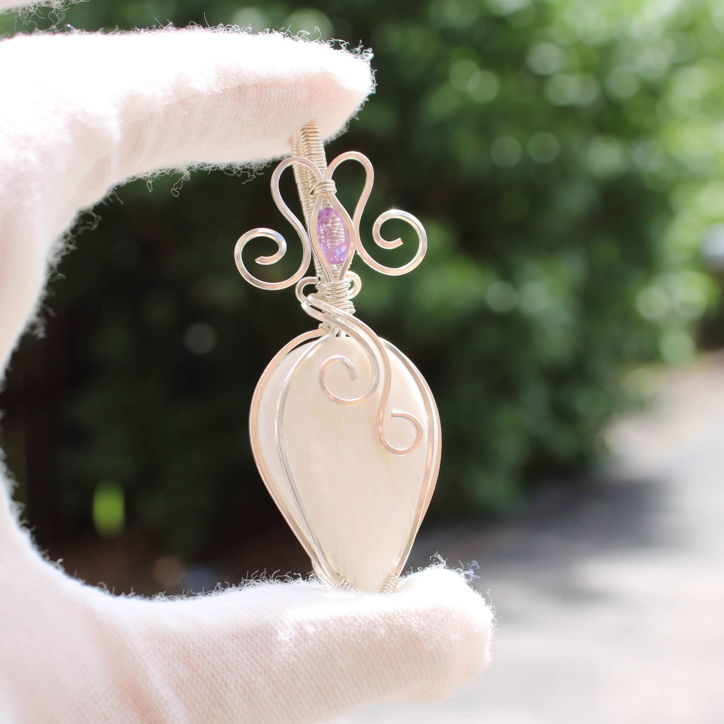Handcrafted jewelry featuring sterling silver with amethyst accent in an elegant teardrop design