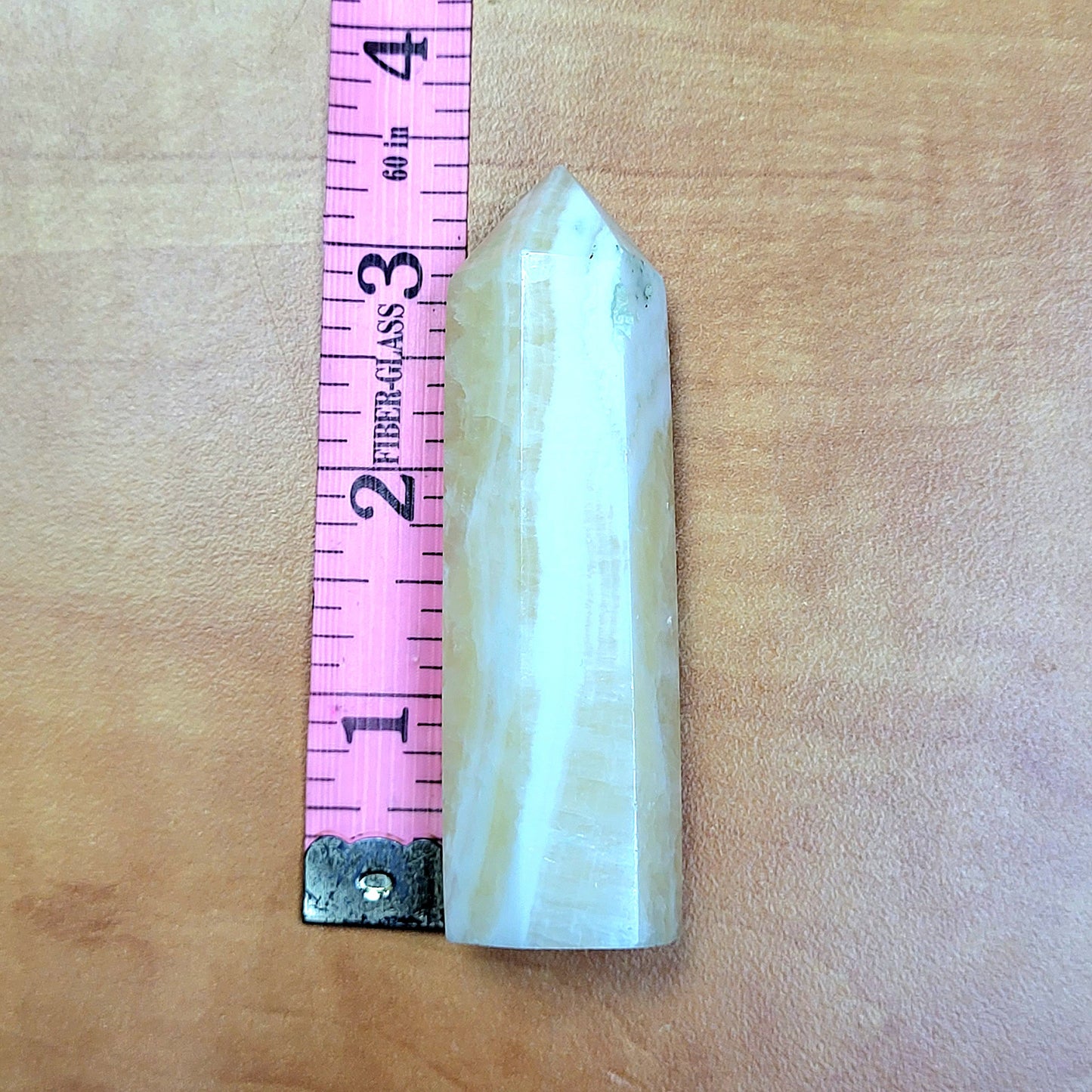 Yellow Calcite Towers showcasing a natural crystal tower with a pointed top for decorative use