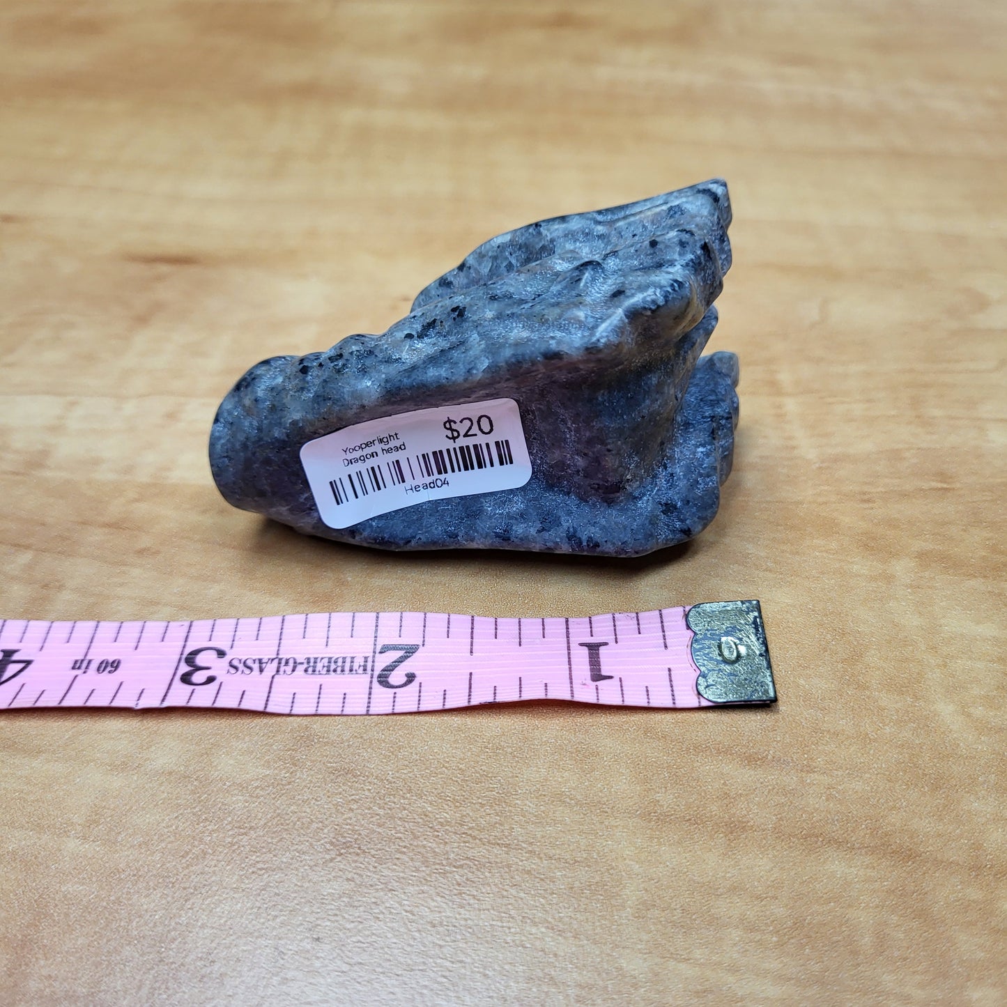 Yooperlight dragon head sculpture in unique blue stone with a price tag for decorative display