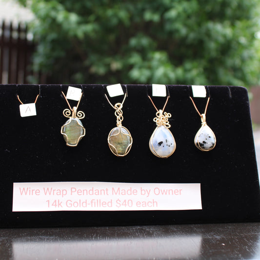 Wire wrap pendants displayed on a black velvet stand, crafted in 14k gold filled jewelry, priced at $40 each