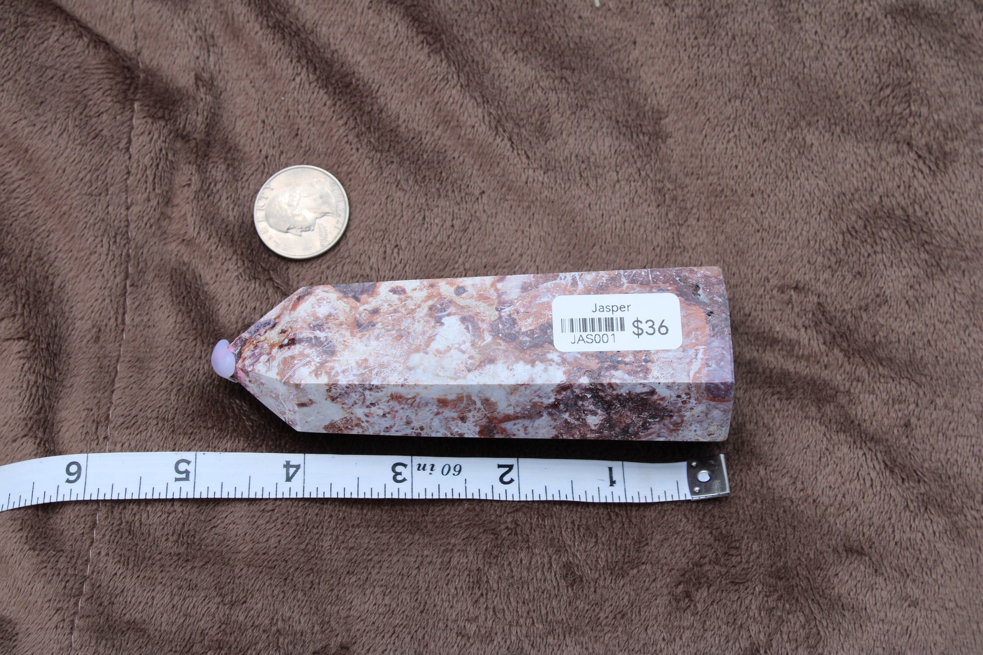 Unique Jasper Polished Crystal Point from the 2024 showroom crystal collection with a measuring tape for size reference