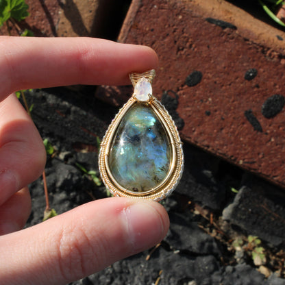 Rainbow Moonstone & Labradorite 14k Gold fill pendant showcased against a natural background