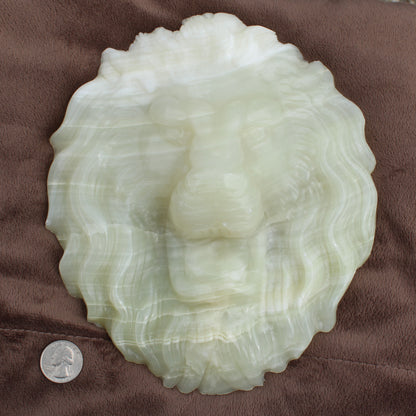 Afganistan Jade Lion head crystal Statement calcite carved detailed lion face next to a quarter for size