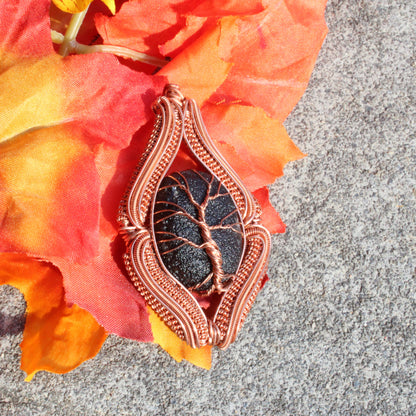 Agni Manitite Obsidian Pendant in Copper Wire Design on Colorful Autumn Leaves