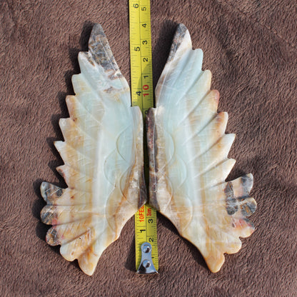 Different Branches LLC Amazonite Owl Wings crystal in natural shades with measuring tape on brown fabric