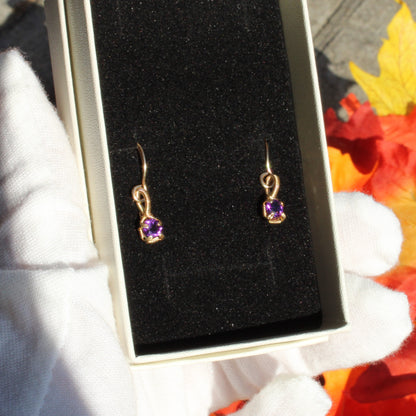 Amethyst 14k Gold-filled earrings displayed in a jewelry box with soft black lining