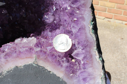 Amethyst Cathedral with purple crystals showcasing unique formations and a quarter for size reference