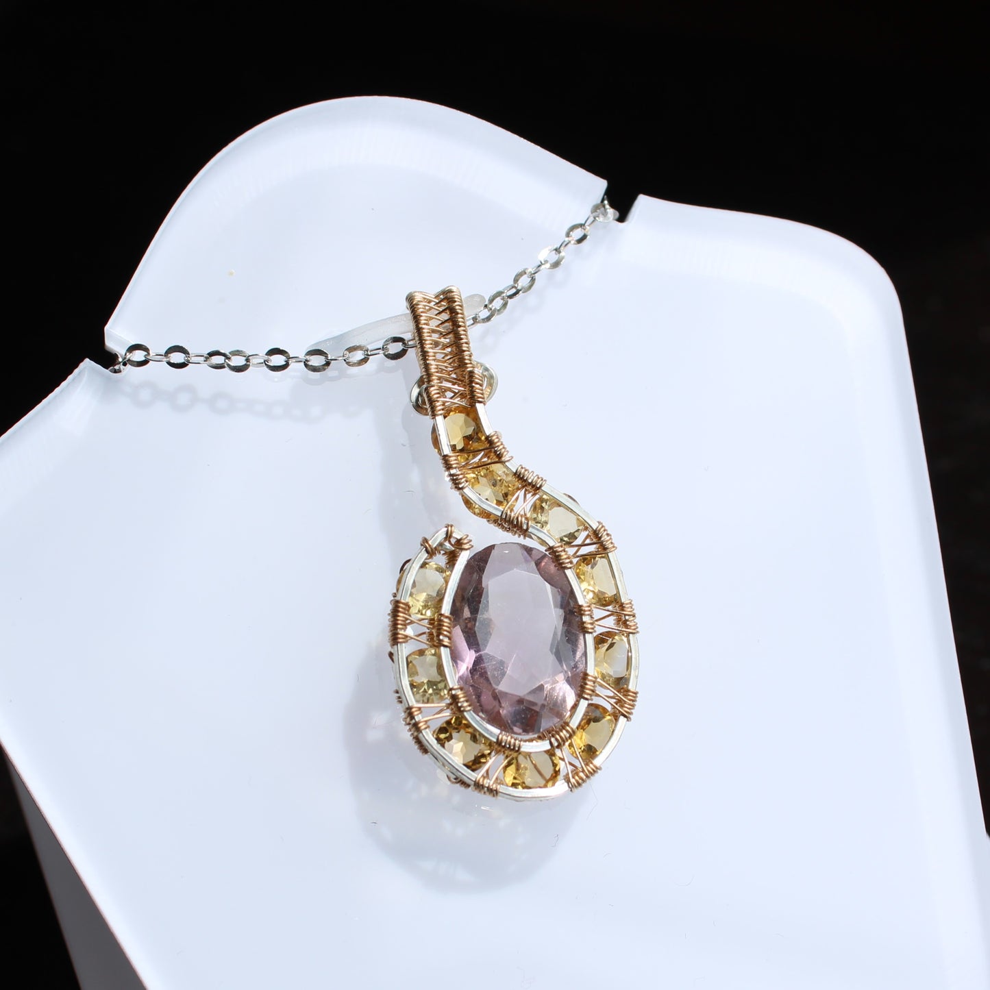 Elegant amethyst citrine pendant with intricate gold detailing and a shimmering chain
