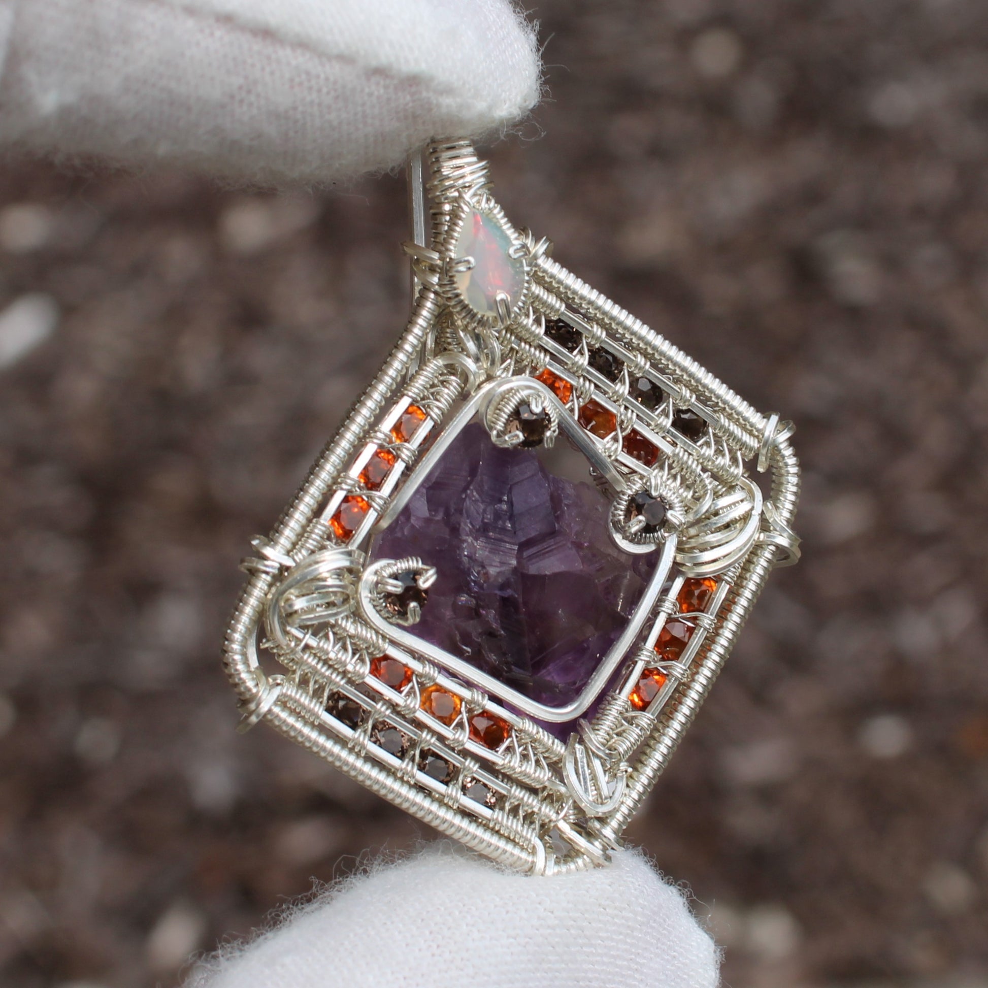 Handcrafted jewelry pendant featuring amethyst garnet opal silver wire wrapping by Different Branches LLC