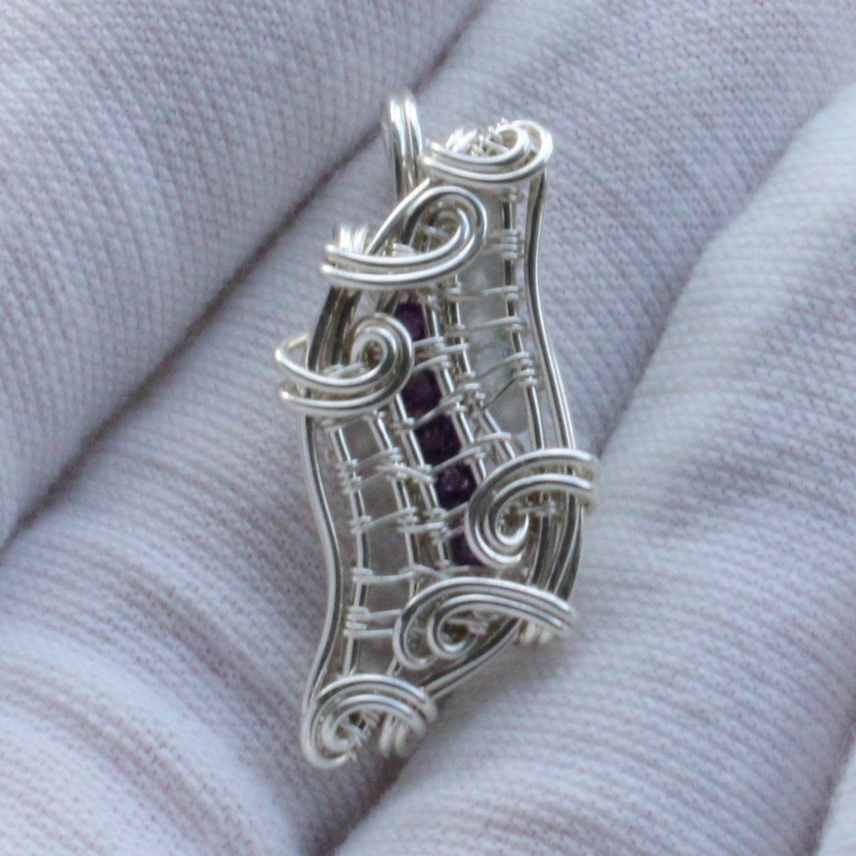 Sterling silver pendant featuring Amethyst and Moonstone in a unique wire design