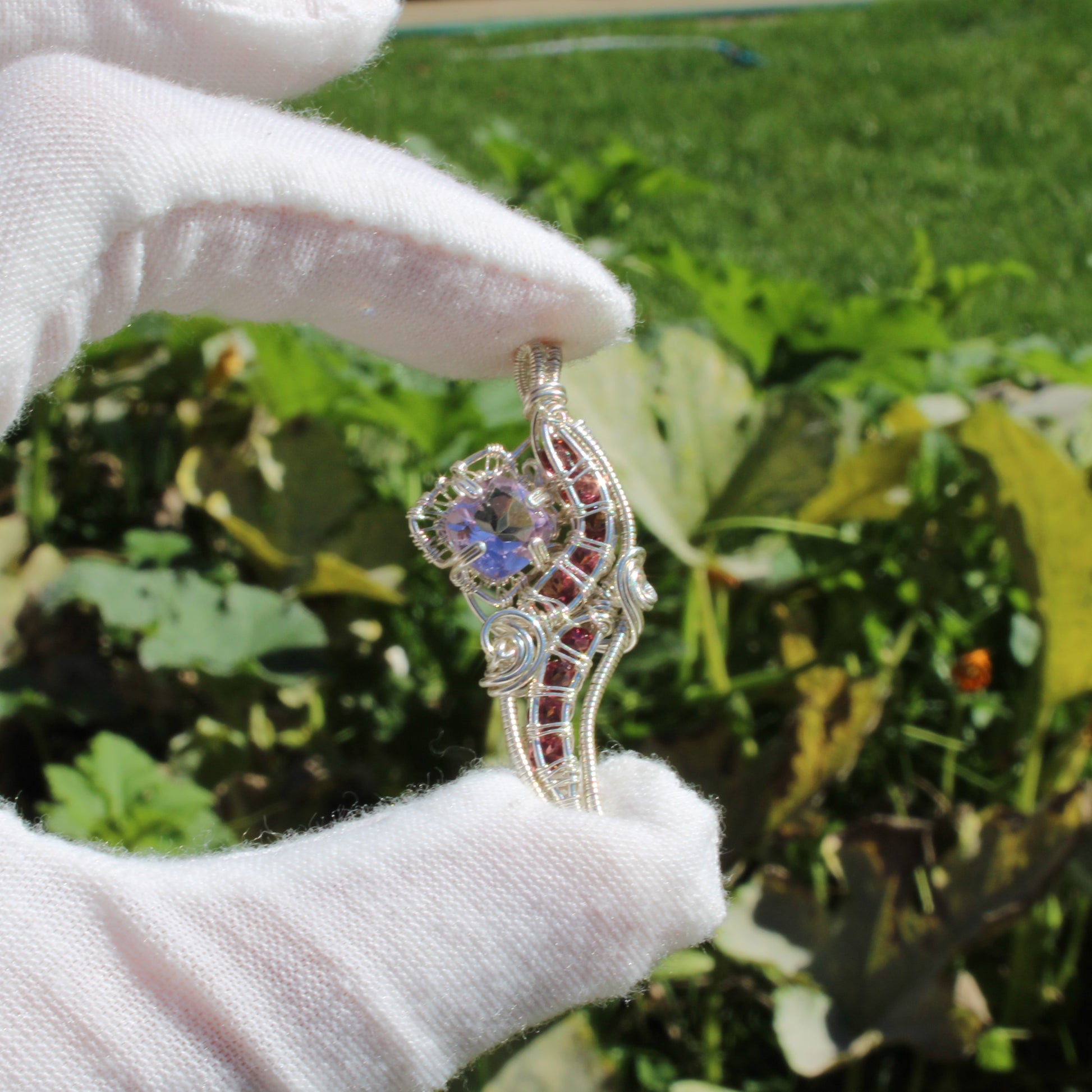 Amethyst Sterling Silver Pink Tourmaline Pendant with Intricate Design Held in Hand