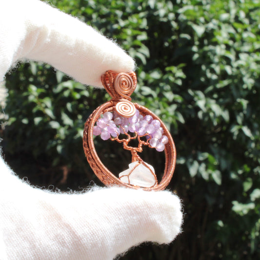 Handcrafted amethyst tree of life pendant with delicate branches and sparkling gemstones.