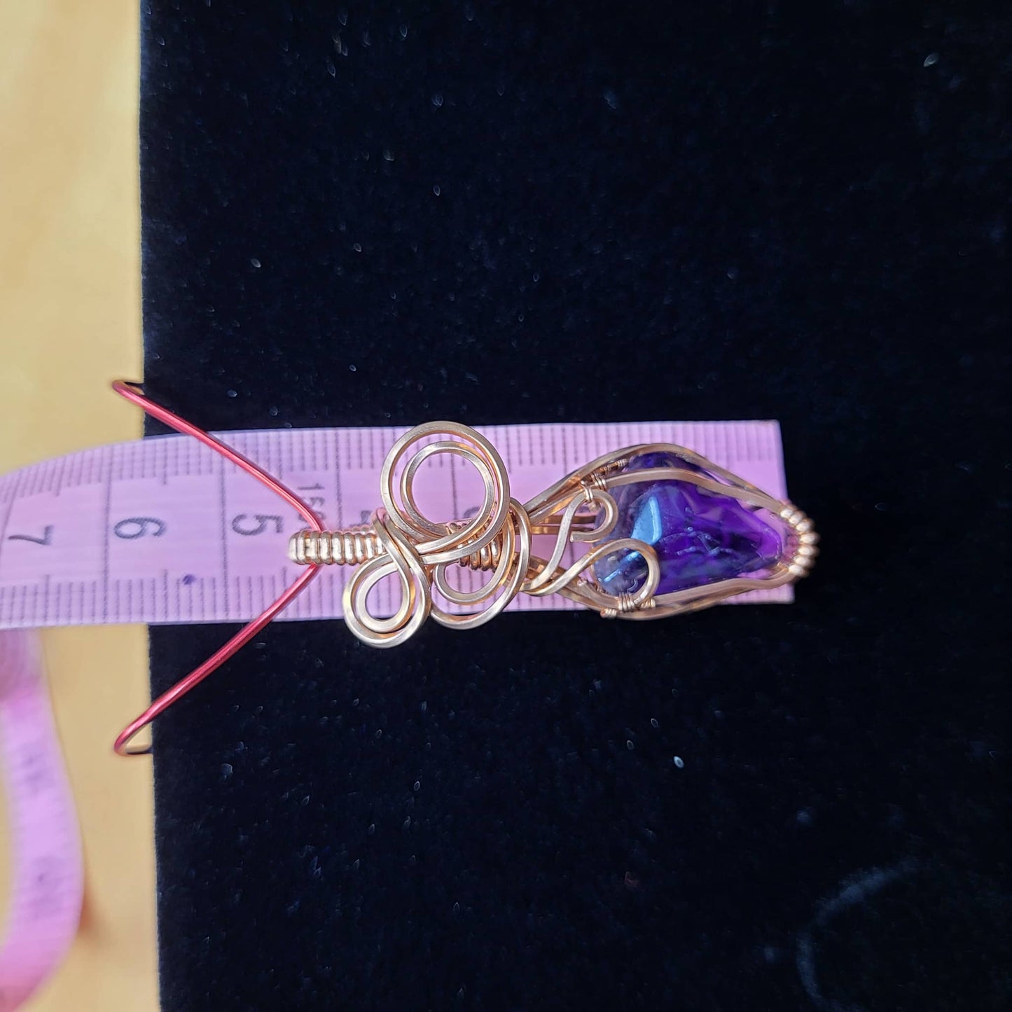 Handcrafted Amethyst Pendant in Gold Wire with Unique Swirl Design on Measuring Strip