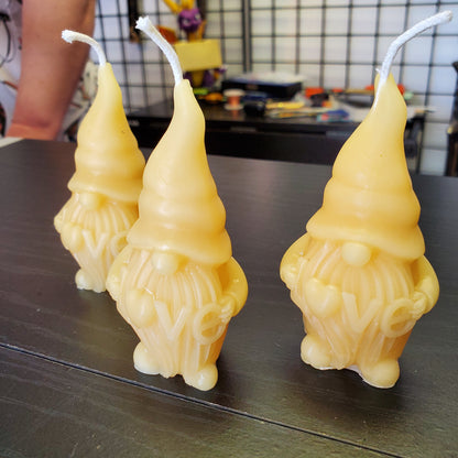 Beeswax gnome candle trio featuring cheerful gnome shapes in natural beeswax color