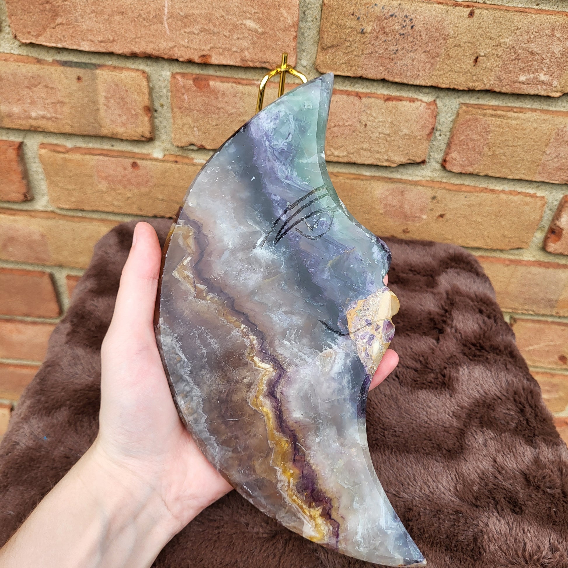 Hand-held Big Rainbow Fluorite Moon with intricate colors and patterns, ideal for decor or gifts