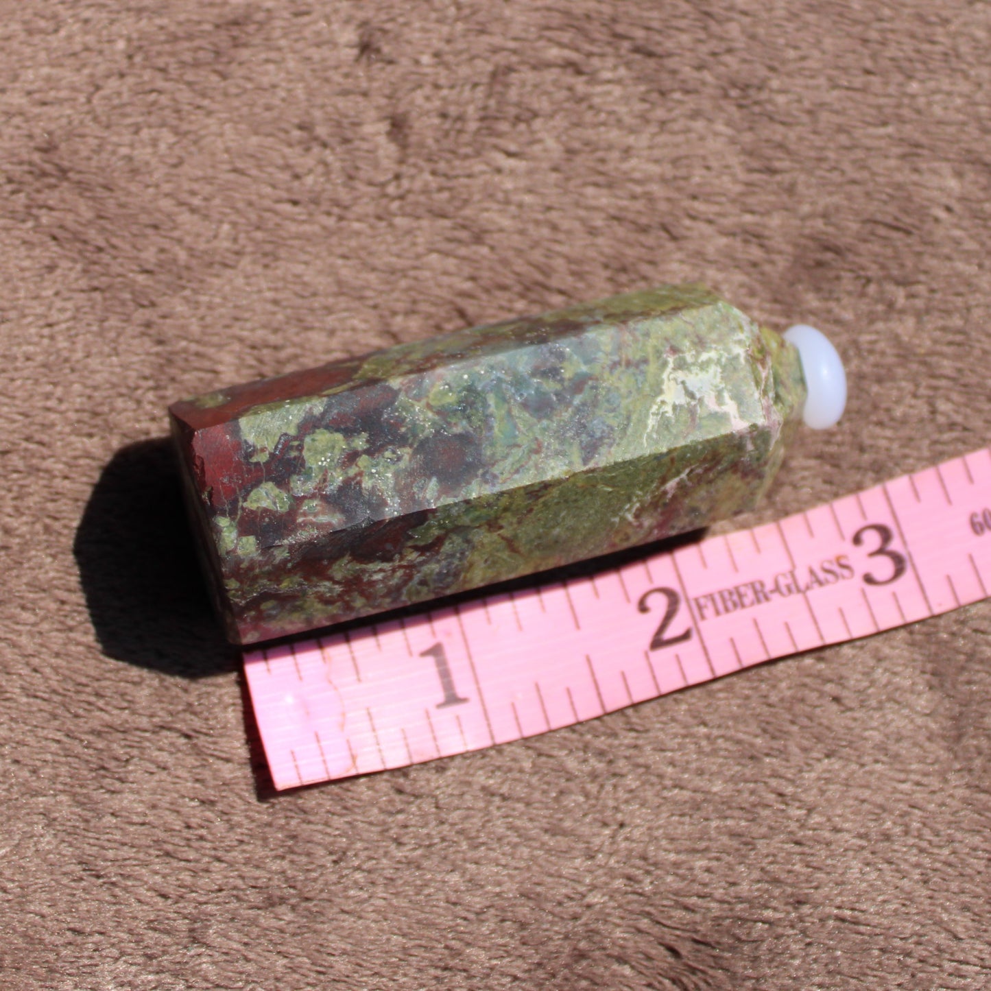 Bloodstone tower featuring unique green and red patterns with a polished finish for decorative use