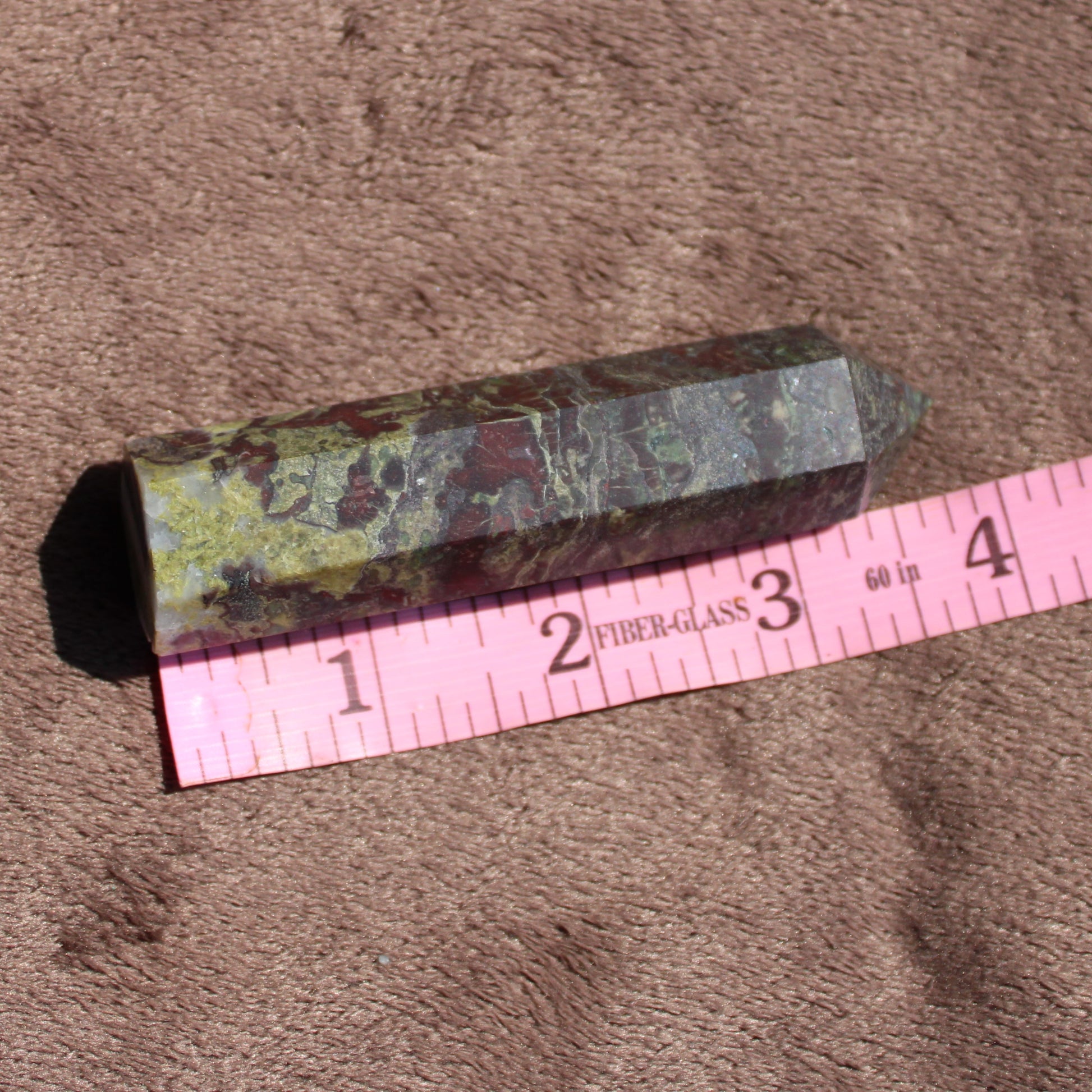 Polished Bloodstone tower for meditation and healing, showcasing rich green and red colors.