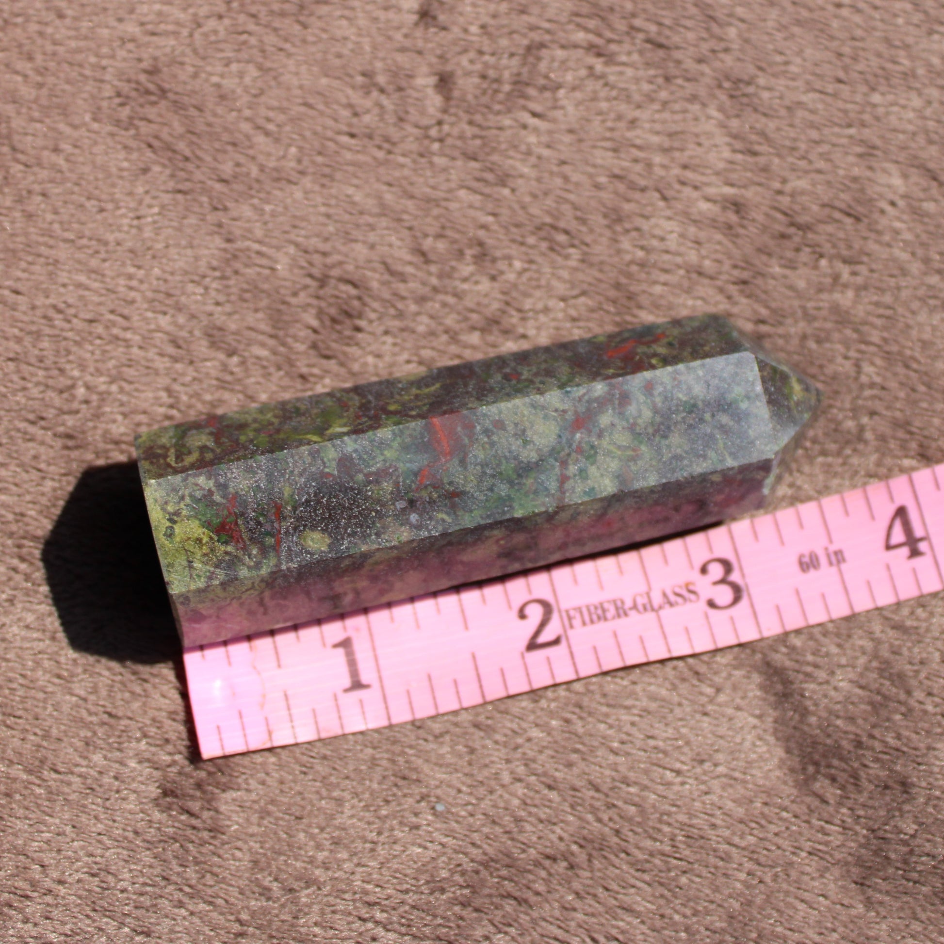 Bloodstone tower displaying vibrant green and red colors with a pointed tip for decorative use