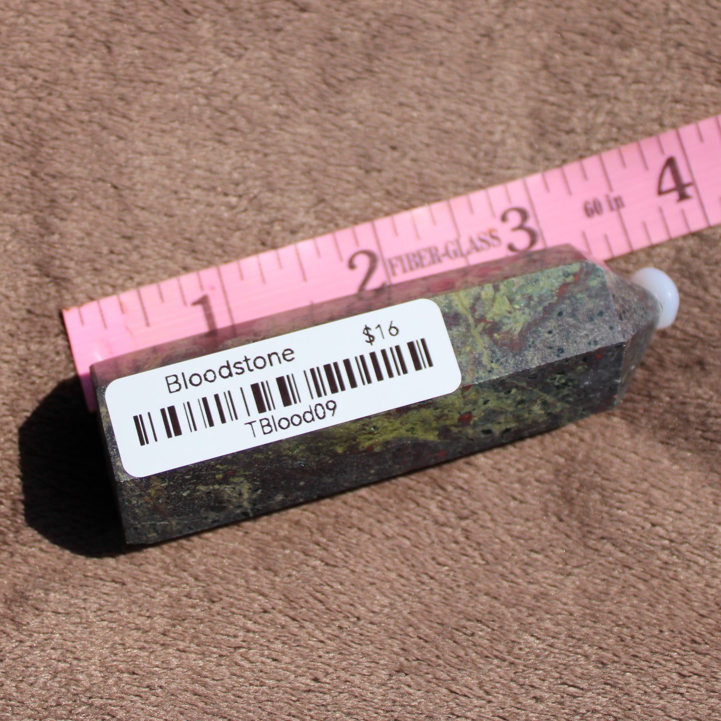 Bloodstone tower crystal in a unique shape, showcasing rich earthy colors and textures