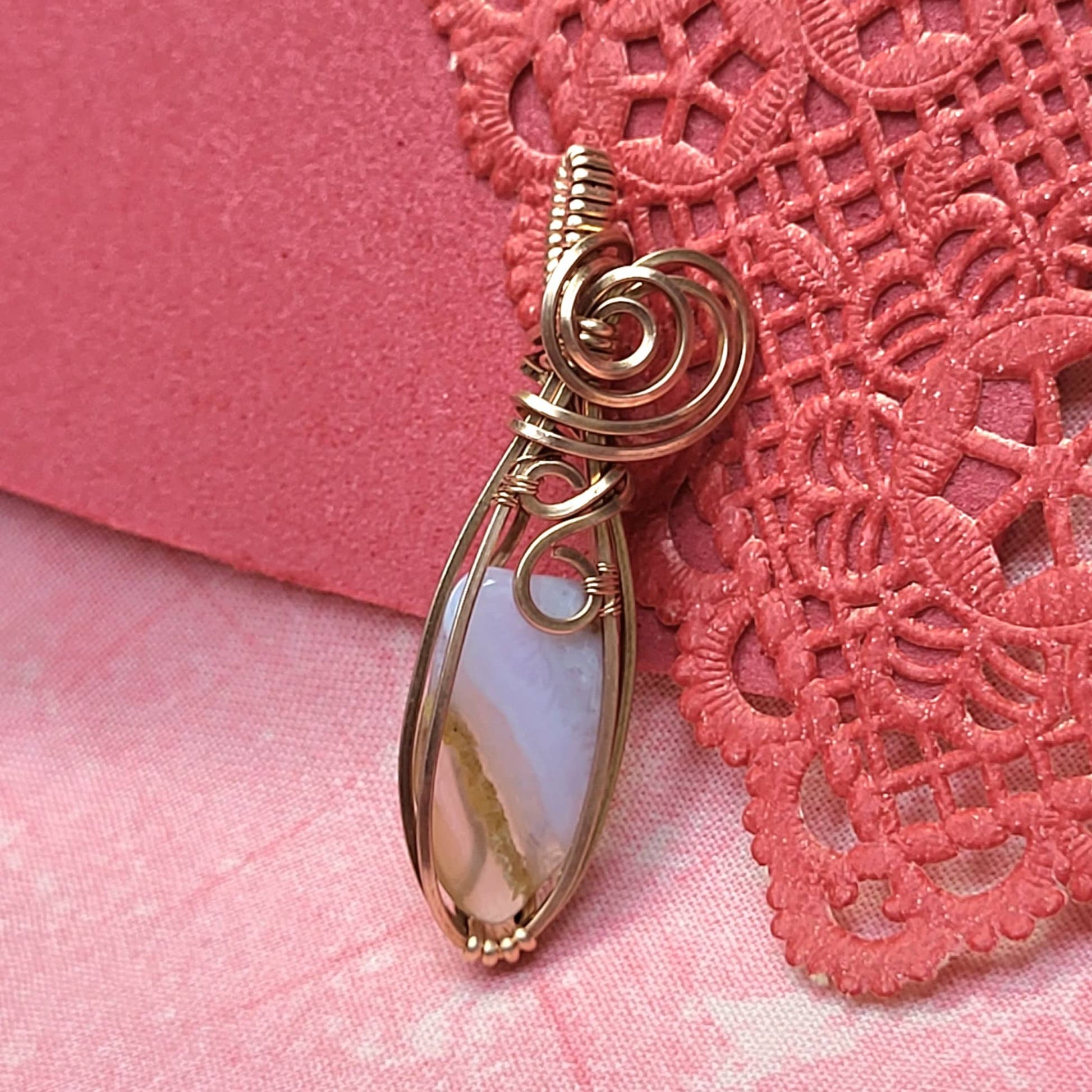 Elegant wire-wrapped pendant featuring a stunning blue chalcedony stone, perfect for jewelry lovers.