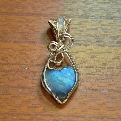 Elegant blue flash labradorite heart pendant wrapped in gold wire for unique jewelry lovers