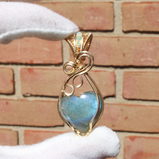 Blue flash labradorite heart pendant in a gold wire wrap setting, showcasing its vibrant colors