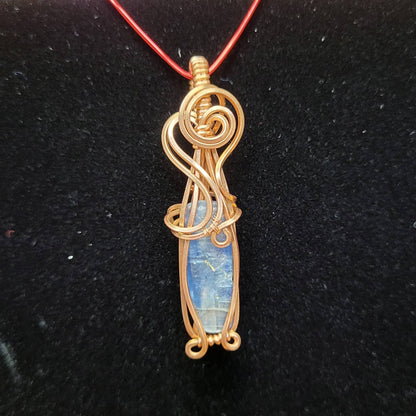 Handcrafted Blue Kyanite Pendant Wrapped in Gold Wire on Red Cord Necklace