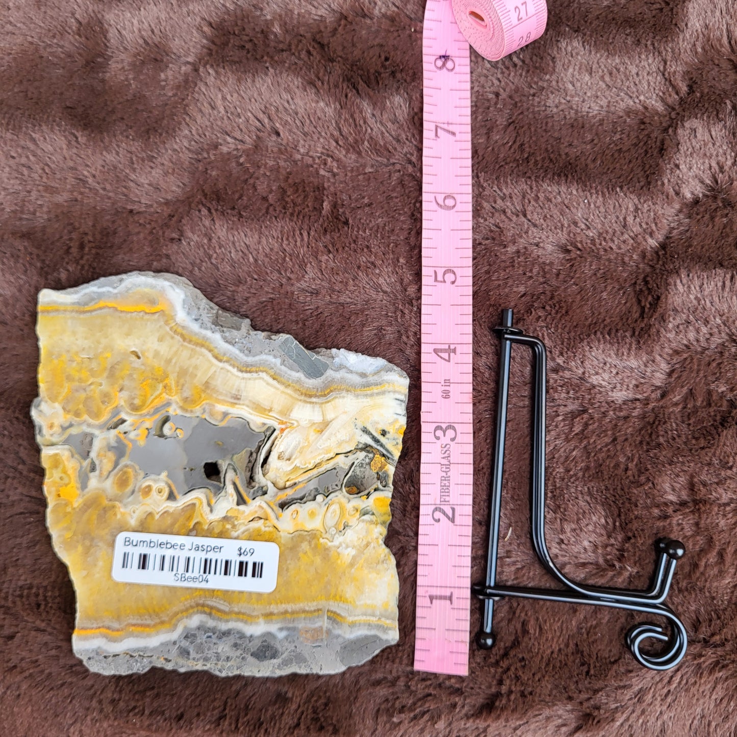 Bumblebee Jasper Slabs with vibrant yellow and gray patterns displayed next to a ruler for size reference