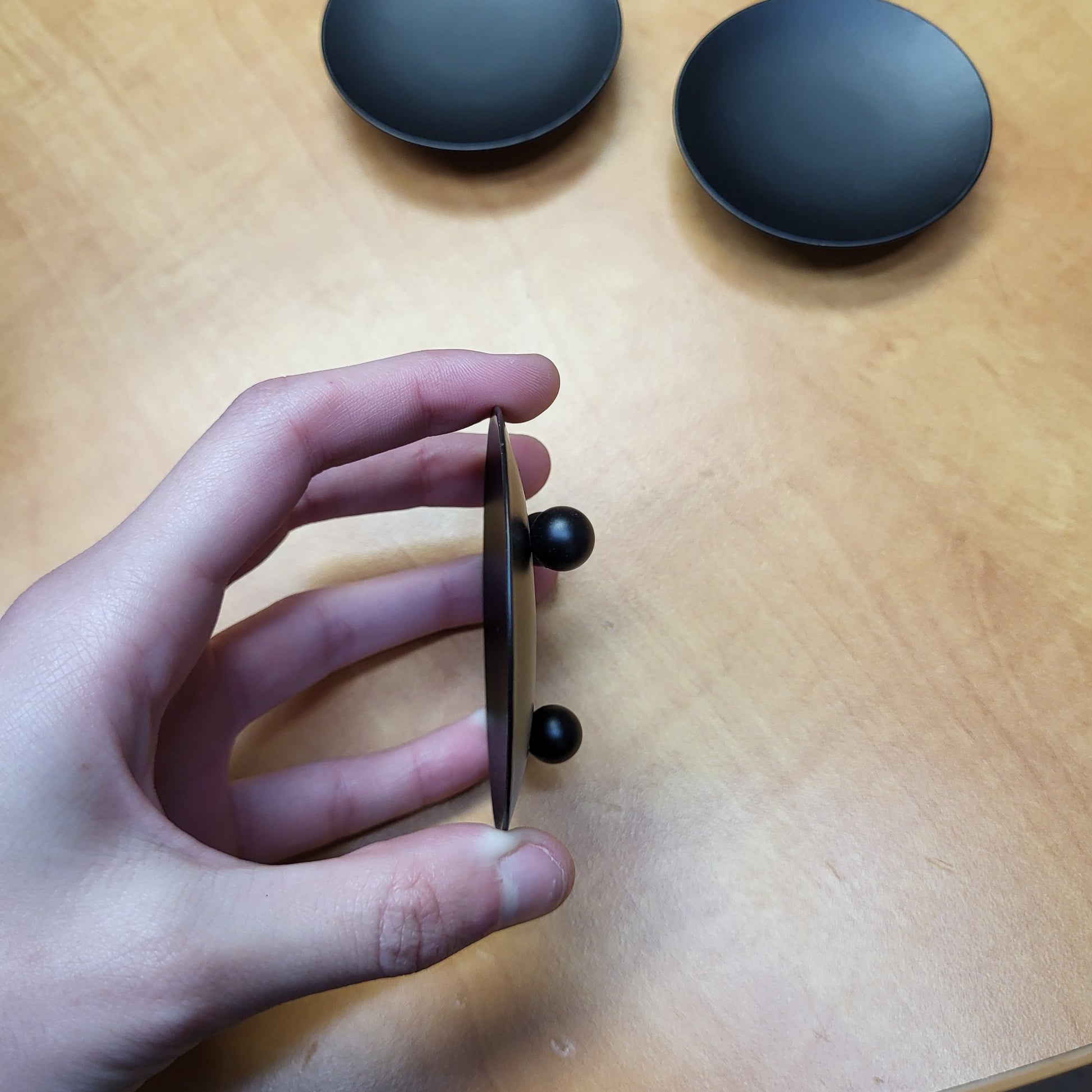 Hand holding black candle dish from Different Branches Crystal Gift Shop for elegant candle display