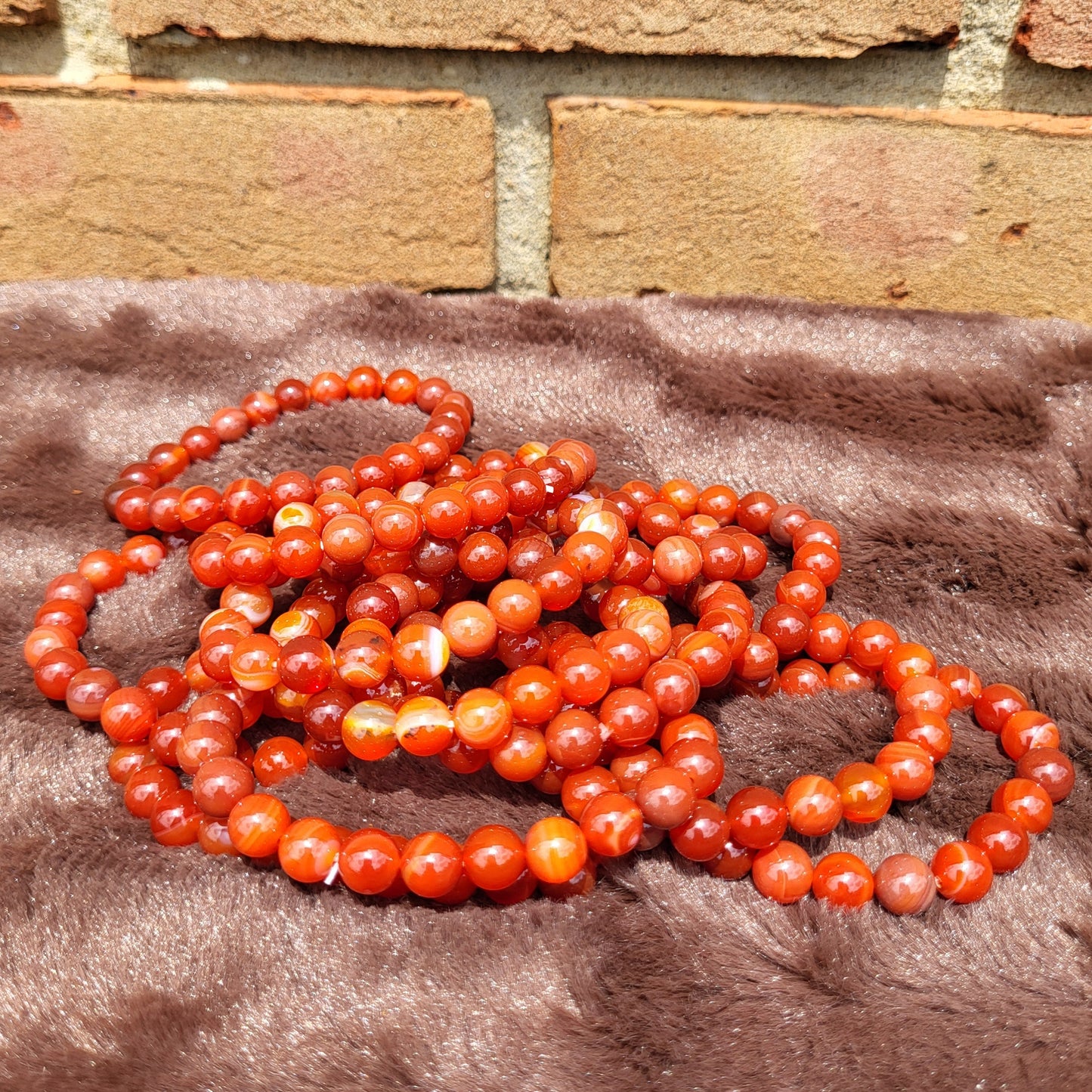 Carnelian bracelet set featuring multiple strands of vibrant red-orange beads for stylish accessories