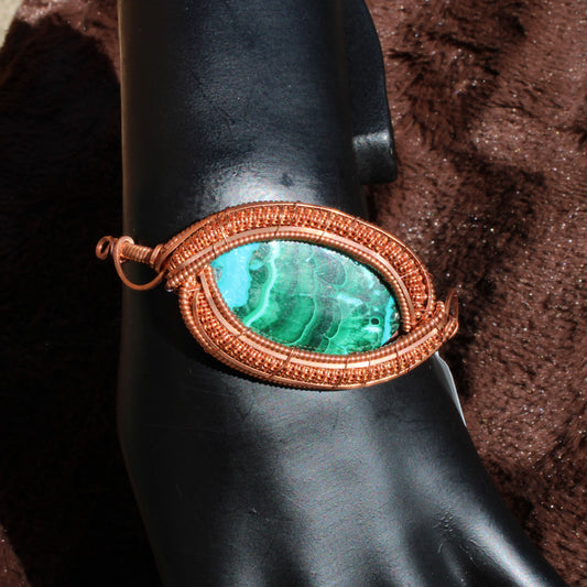 Chrysocolla Malachite Bracelet showcased on a black display with intricate copper wire wrapping