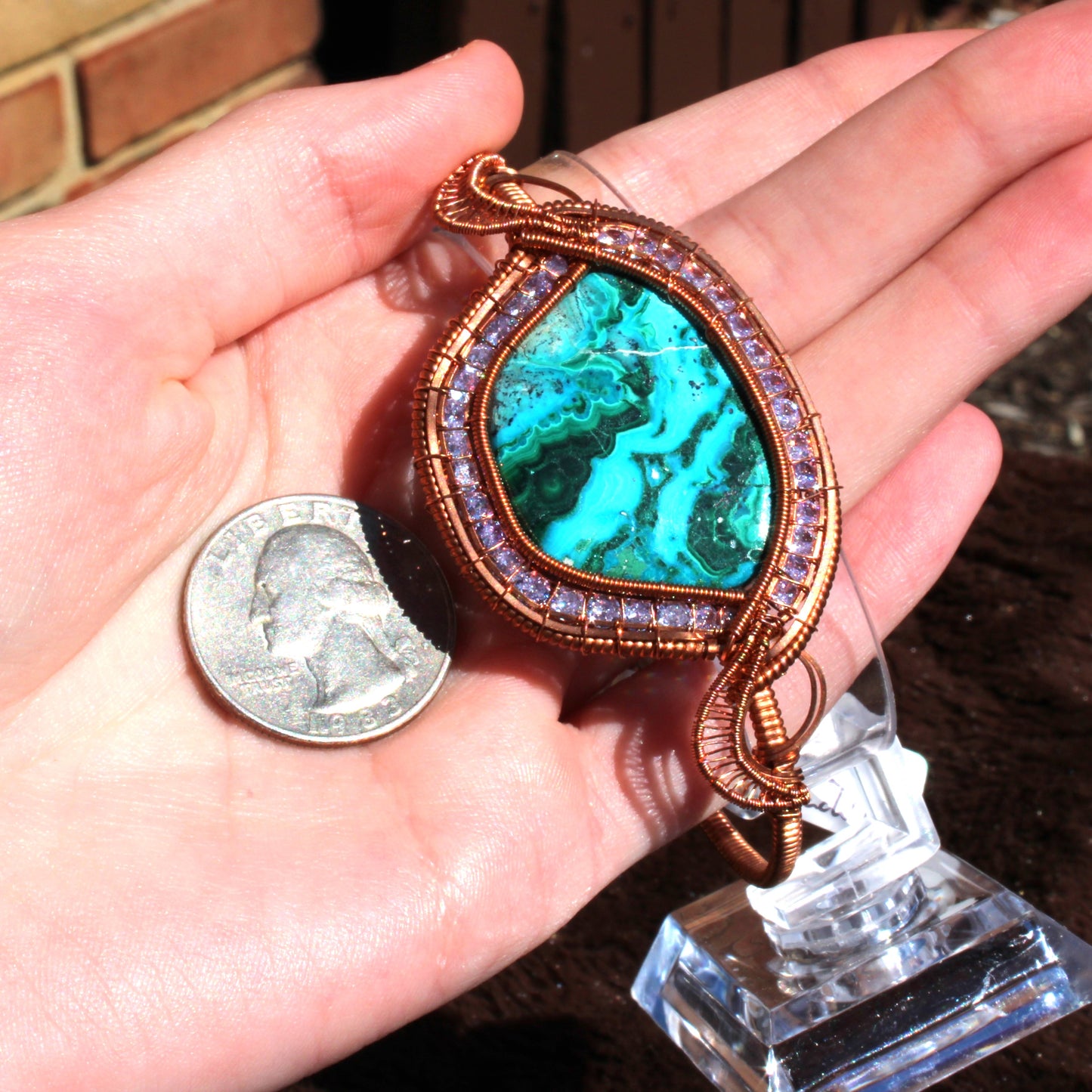 Chrysocolla malachite cz bracelet showcased in hand next to a quarter for size comparison