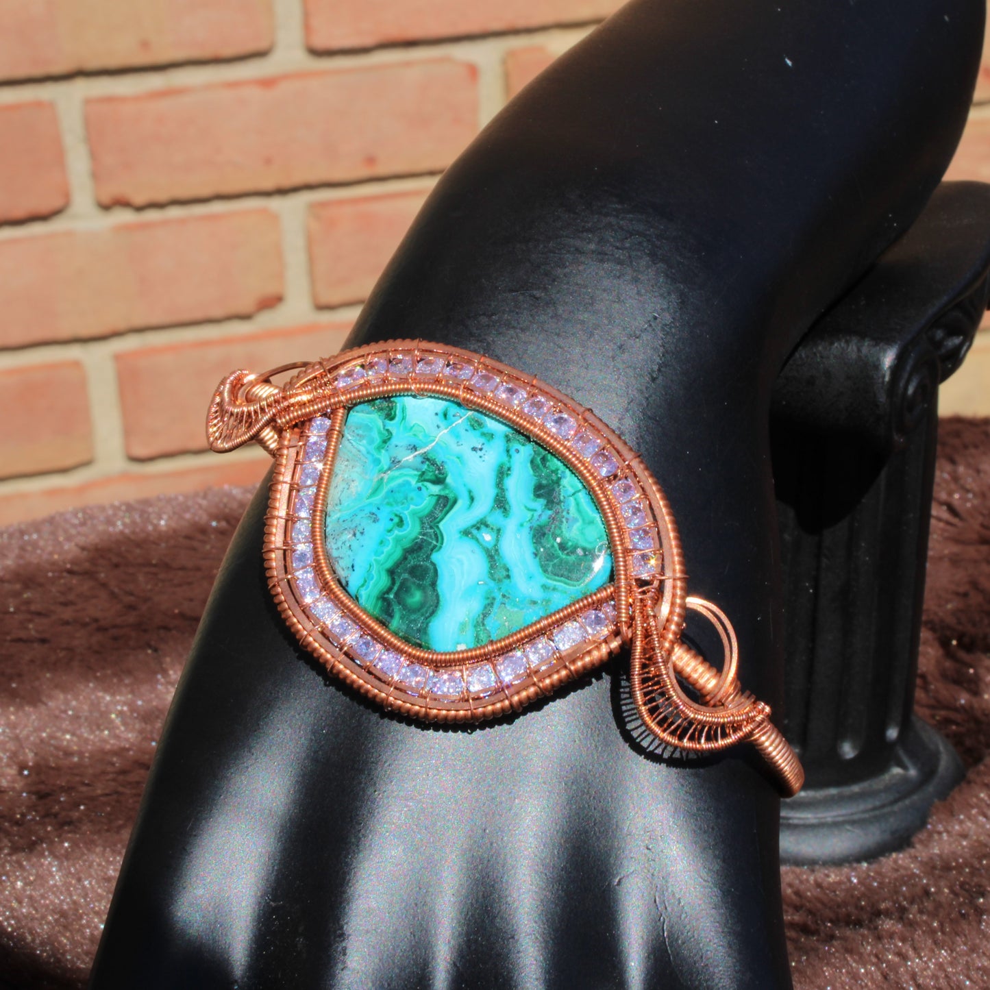 Chrysocolla malachite cz bracelet featuring a stunning green stone set in copper wire on display