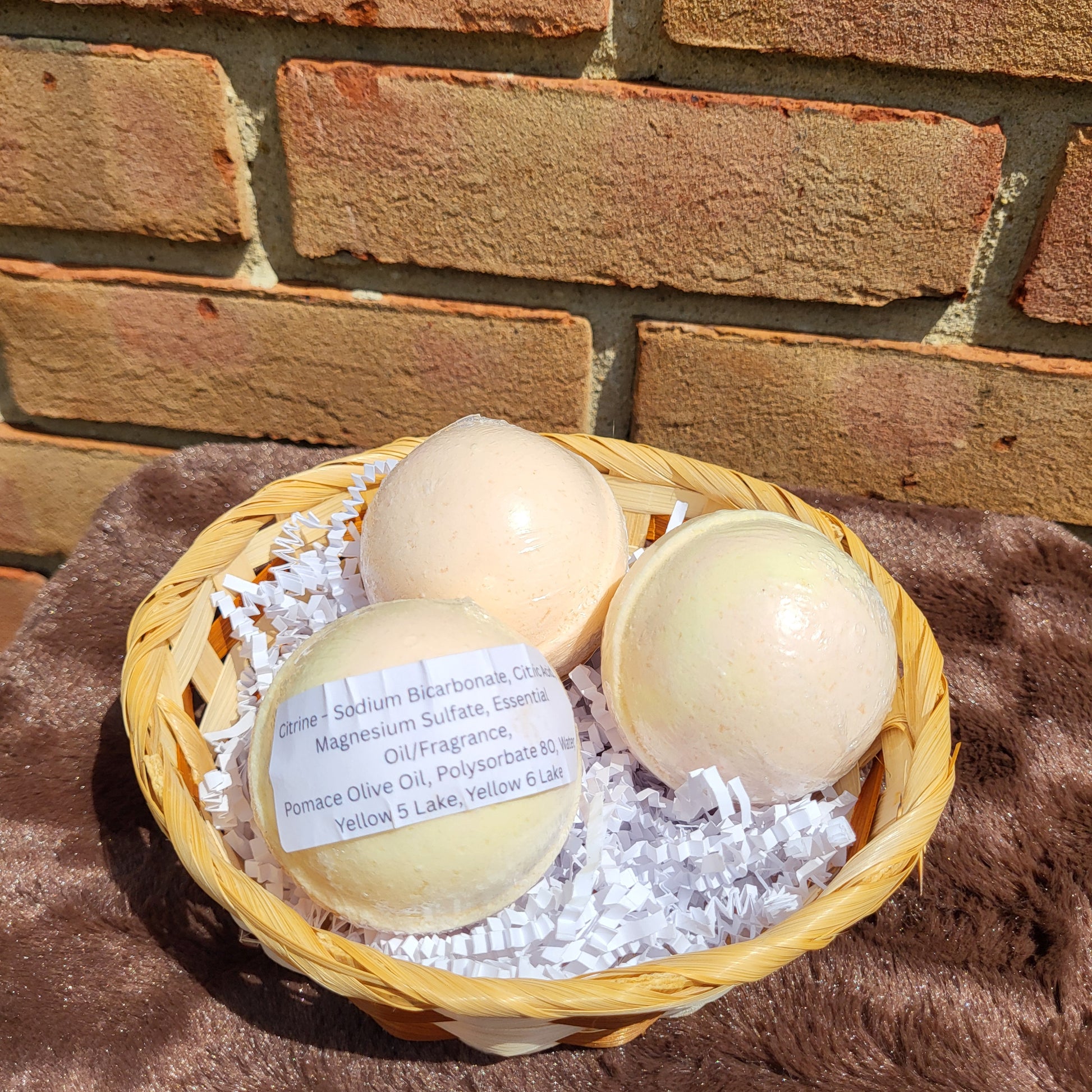 Citrine Bath Bombs in a wicker basket with decorative shreds for a relaxing bath experience