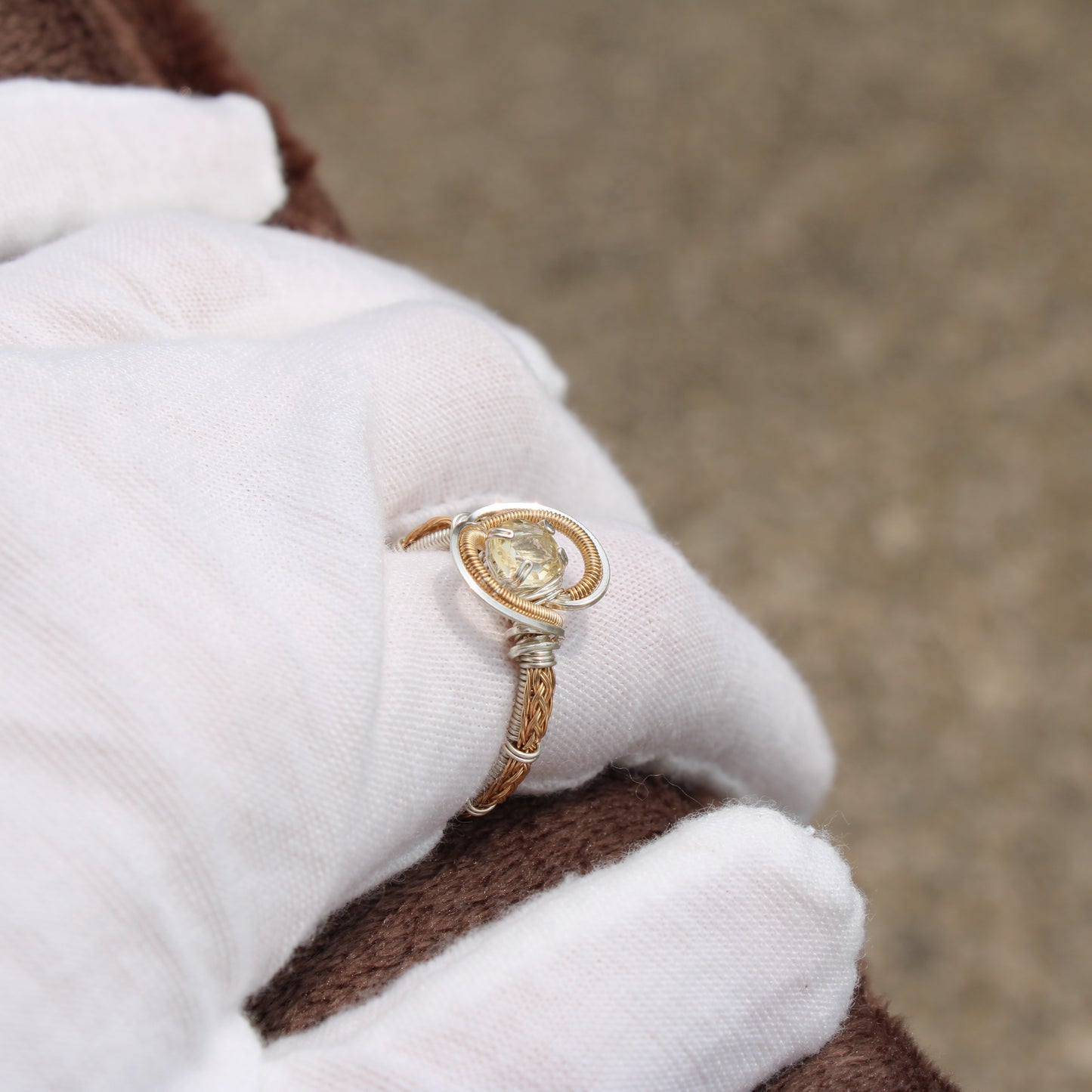 Citrine Sterling Silver Ring with intricate design and pear-shaped gemstone held in a gloved hand