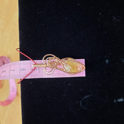 Handcrafted gold necklace featuring a natural citrine pendant with intricate wire design