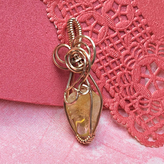 Handcrafted Citrine Pendant Wire Wrapped Jewelry on Pink Background