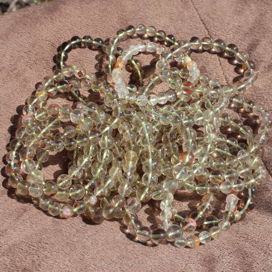 Multiple Clear Quartz Bracelets arranged together showcasing their natural shine and clarity