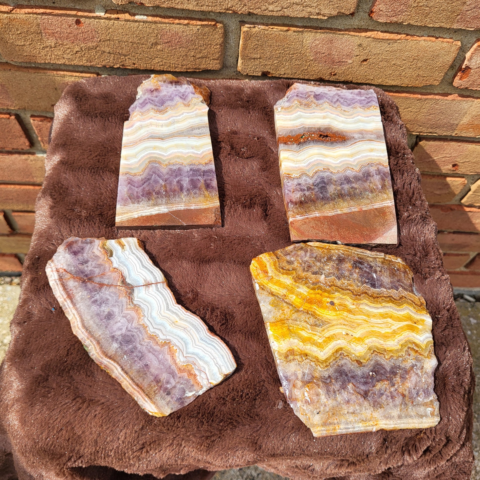 Selection of Crazy lace amethyst slab pieces showcasing unique patterns and vibrant colors