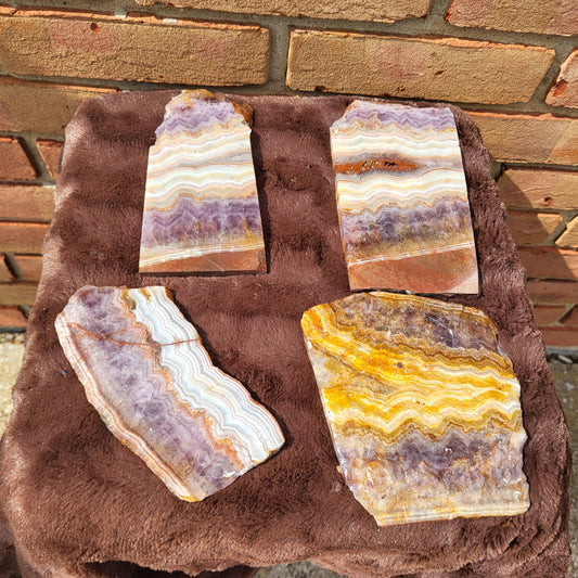 Selection of Crazy lace amethyst slab pieces showcasing unique patterns and vibrant colors