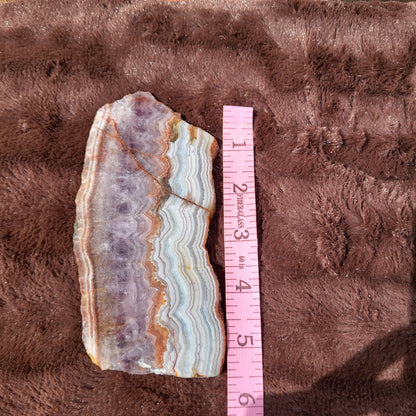 Crazy lace amethyst slab in natural colors with distinctive patterns and smooth edges