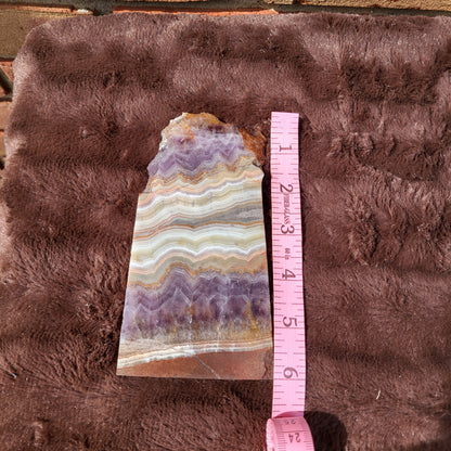 Crazy lace amethyst slab showcasing vibrant purple and white banding for unique home decor