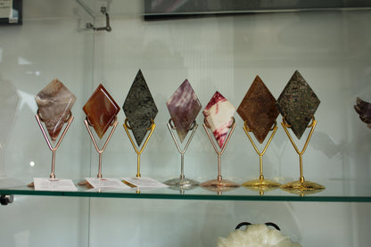 Set of seven Diamond crystals displayed on gold and silver metal stands by Different Branches LLC