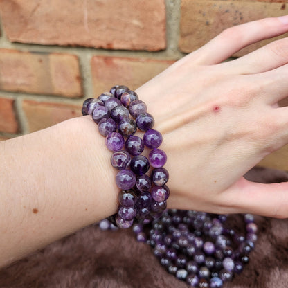 Beautiful Dream Amethyst bracelet stacked on a hand showcasing rich purple hues