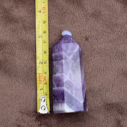 Dream Amethyst Tower crystal measuring approximately 4 inches tall on brown fabric background
